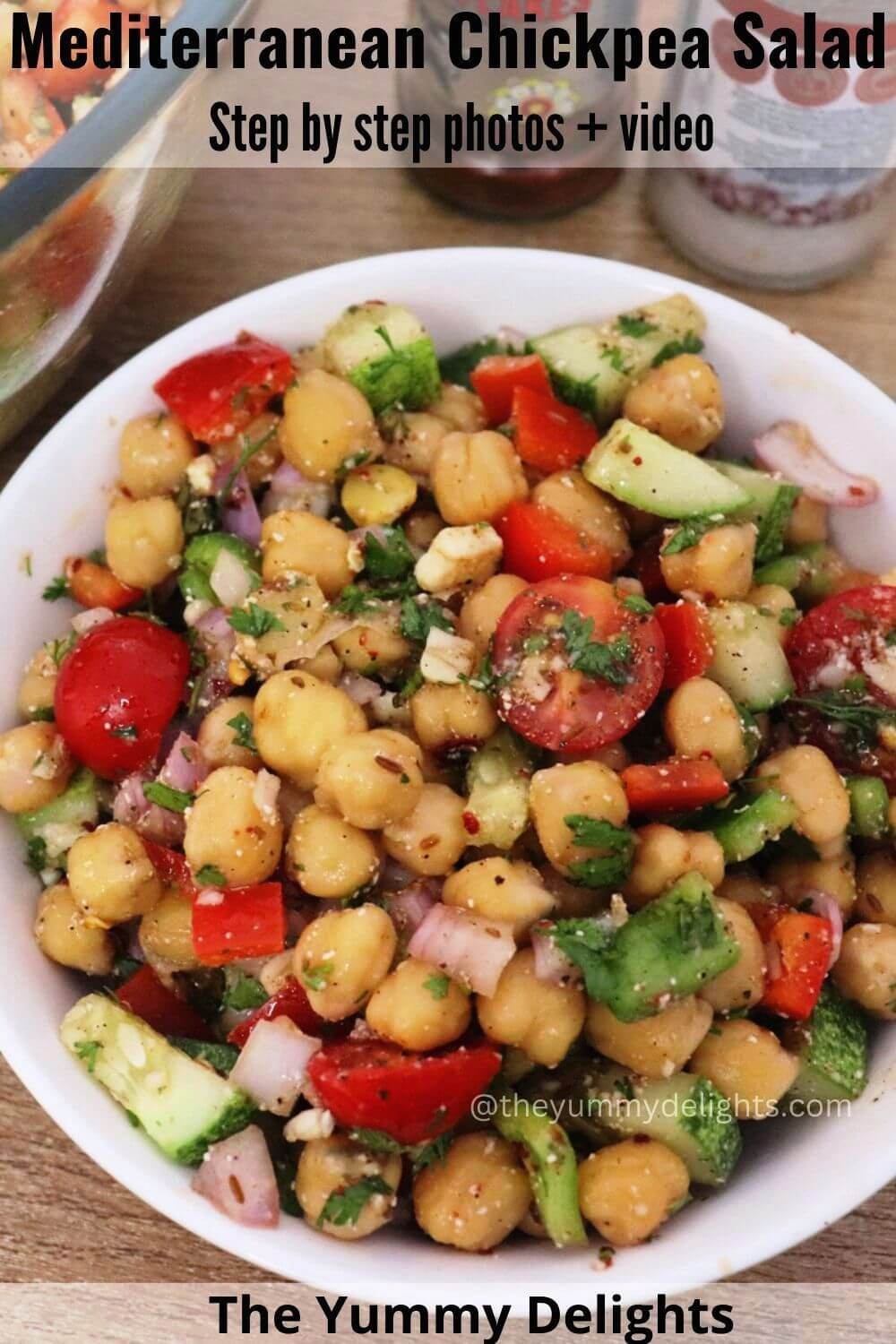 top-view of Mediterranean chickpea salad in a white colored bowl.