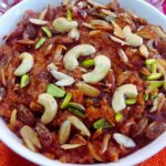 close-up of gajar halwa made in pressure cooker served in a glass jar.