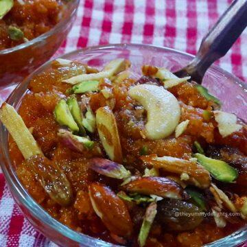 close-up of gajar halwa made in pressure cooker served in a glass jar.