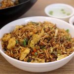 close-up of vegetable egg fried rice served in a white color bowl.