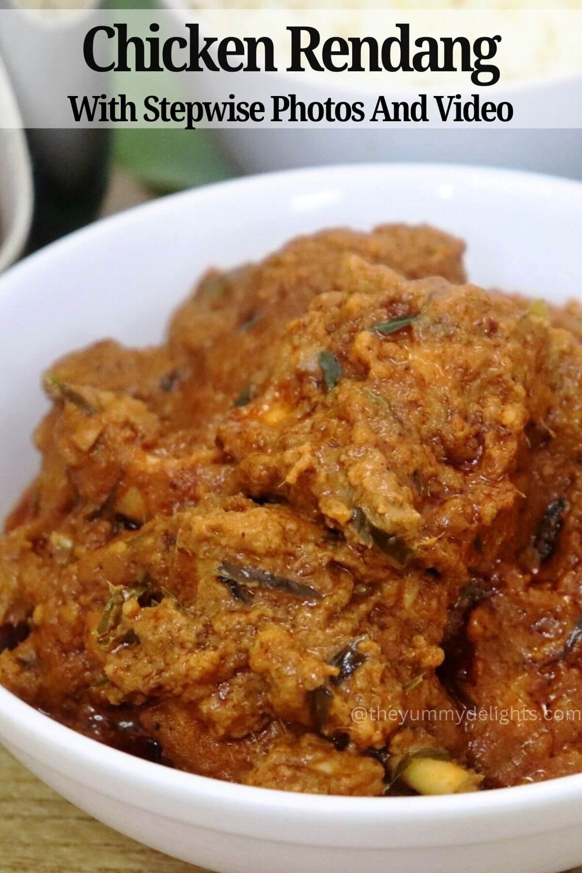 side view of chicken rendang served in a white bowl.