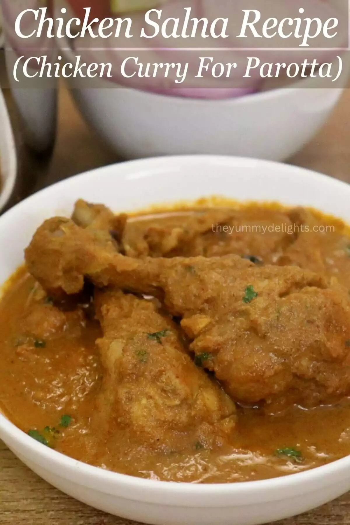 close-up of chicken salna recipe served with bowl full of salad.