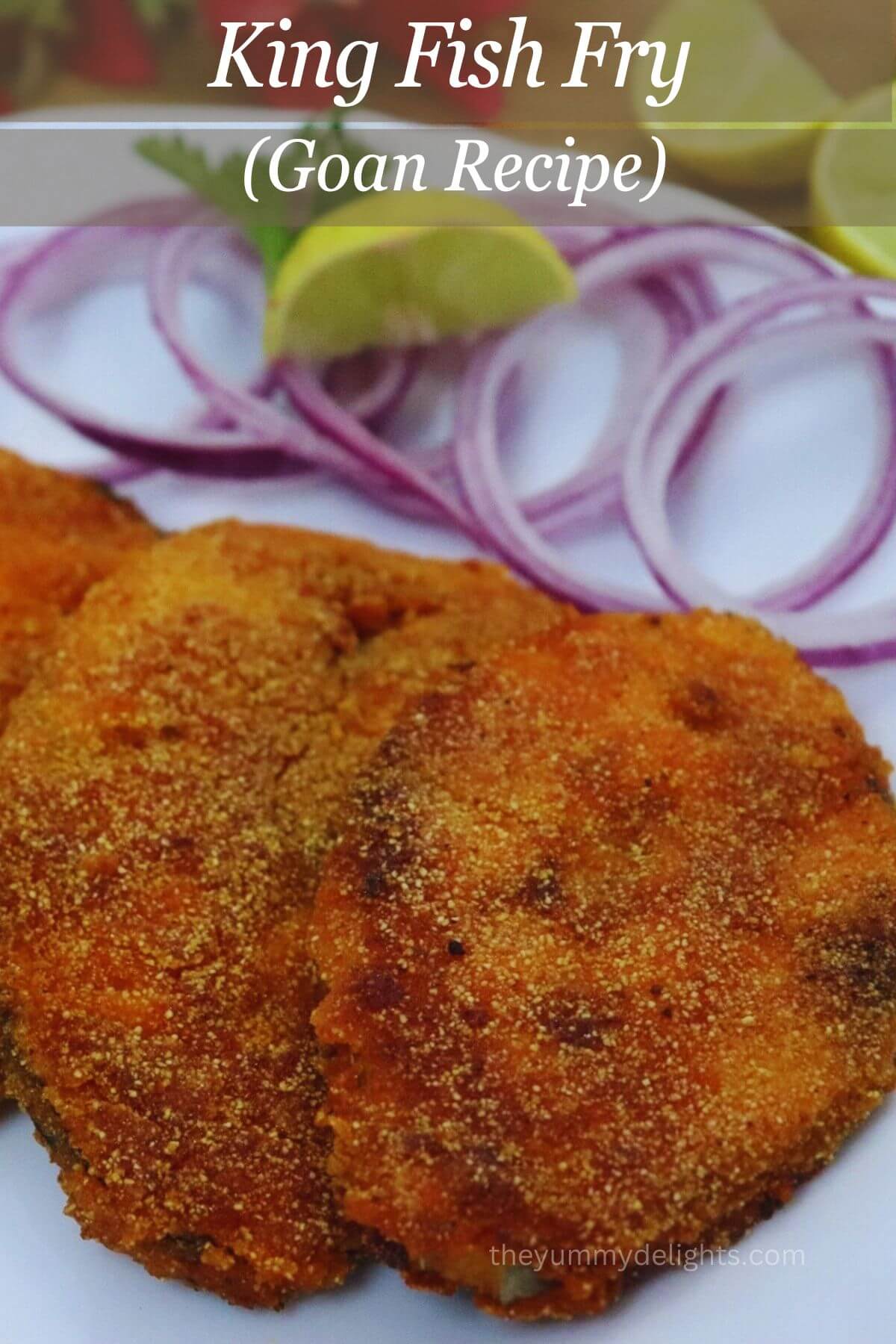 Close-up of crispy goan king fish fry served with lemon wedges and onion rings.