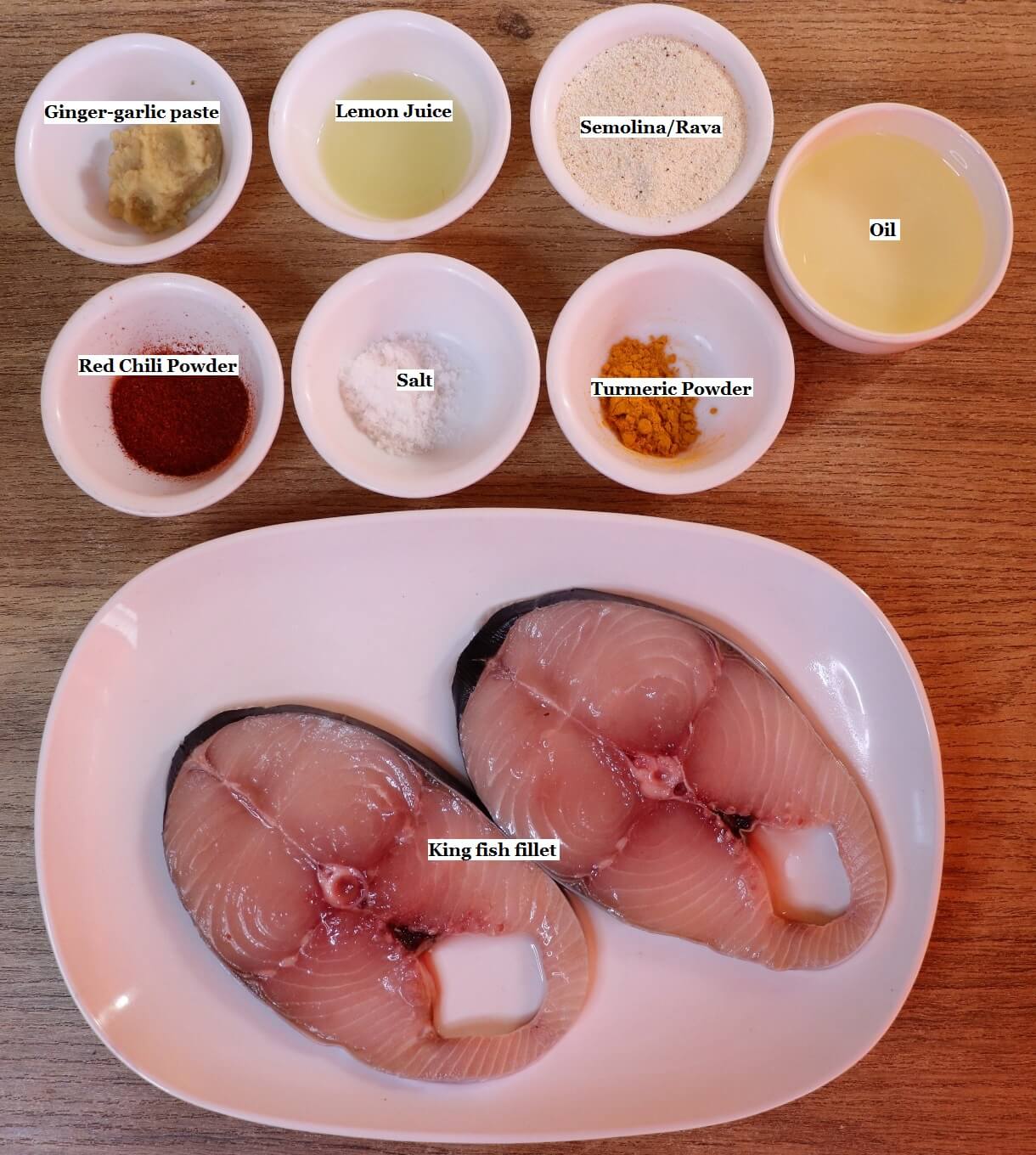 individually labeled ingredients to make king fish fry are laid out on a table.