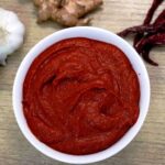 close-up of goan recheado masala in white bowl.