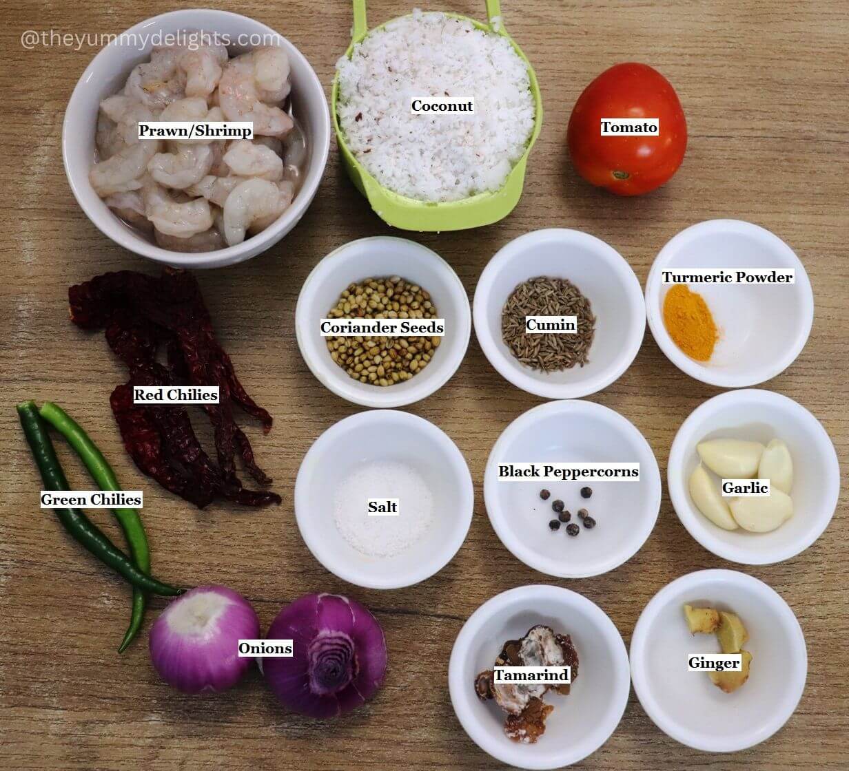 individually labeled ingredients to make goan prawn curry are laid out on a table.