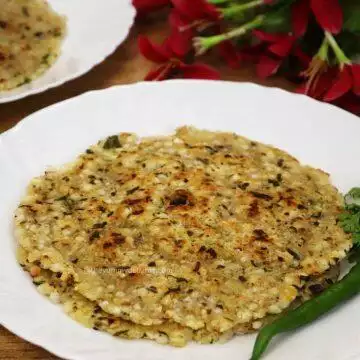 sabudana thalipeeth served on a white colored plate.