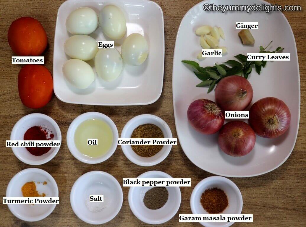 individually labeled ingredients to make kerala egg roast recipe are laid out on a table.