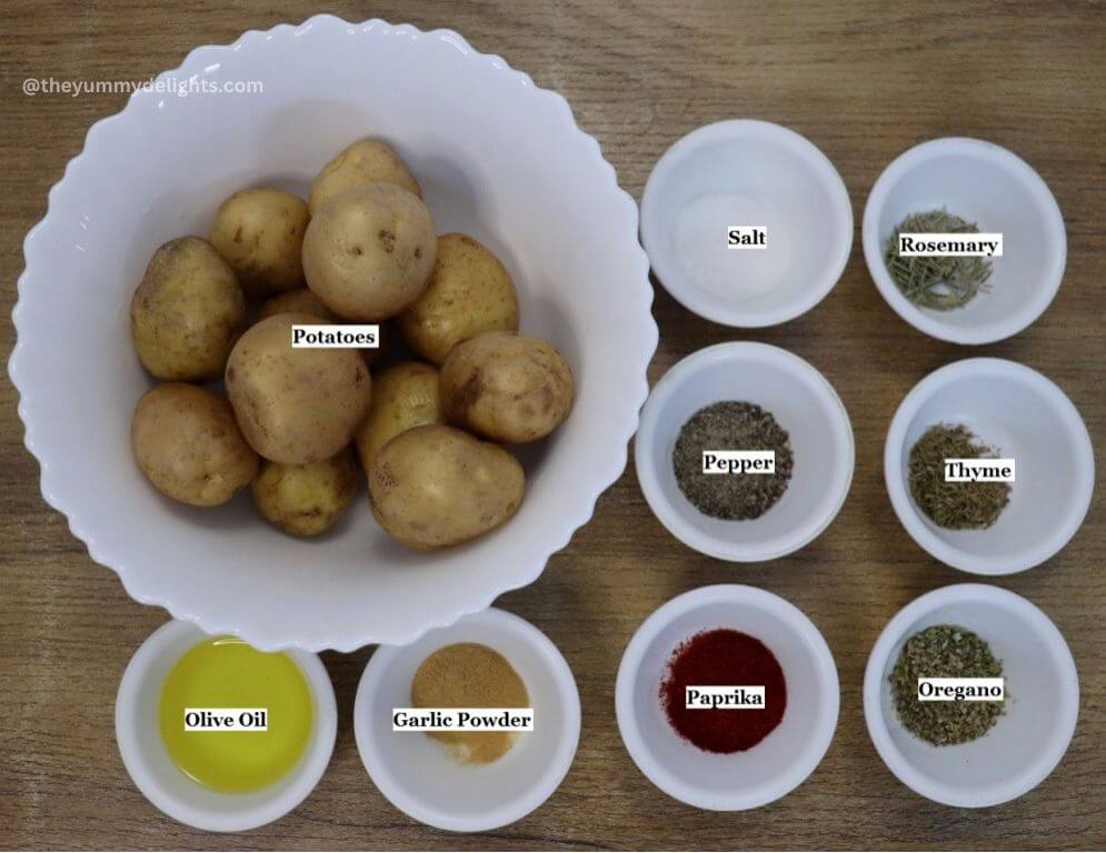 individually labeled ingredients to make roasted mediterranean potatoes are laid out on a table.