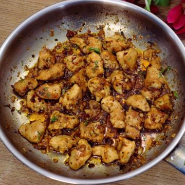 close-up of garlic butter chicken bites in a skillet.