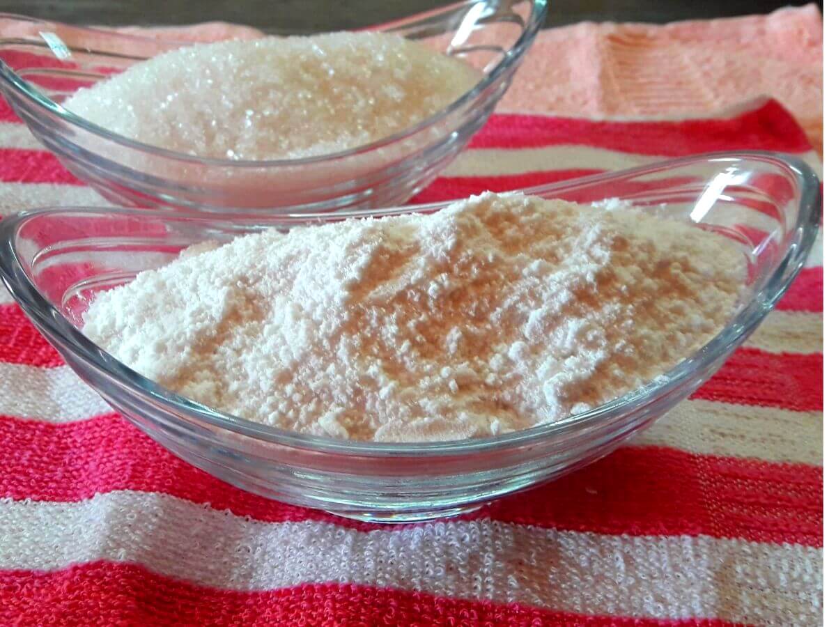 close-up of boora or tagar placed in a glass bowl. Another bowl full of sugar is kept on the side.