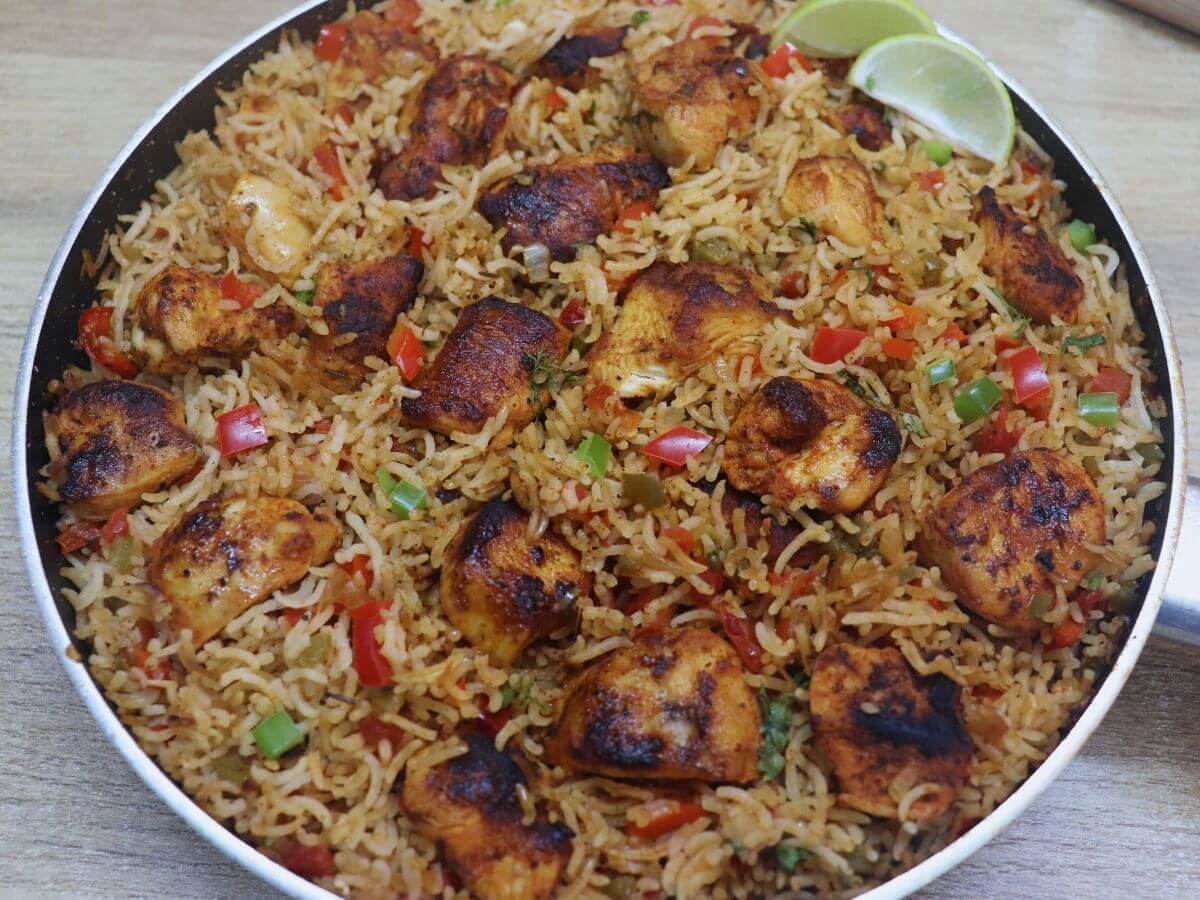 close-up of cajun chicken and rice in a pan.