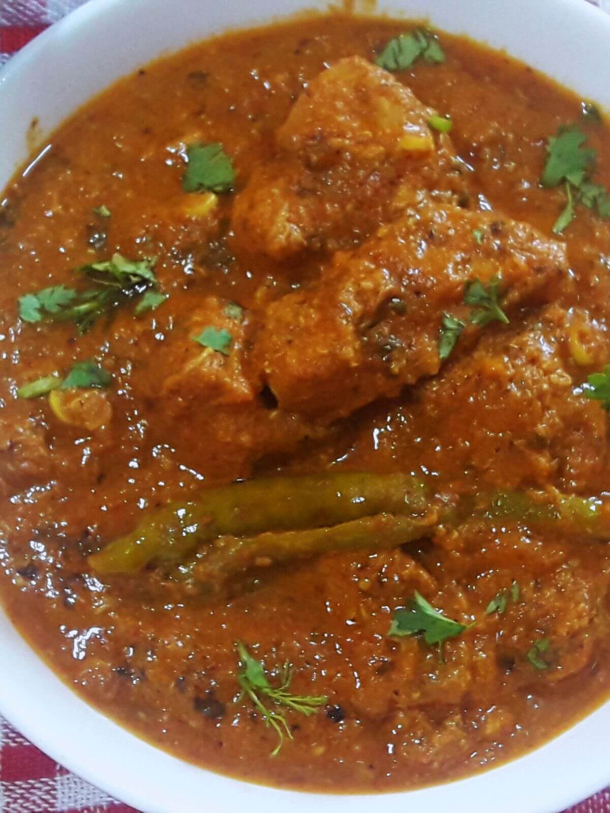 a tight close-up of chicken chengezi garnished with coriander leaves.