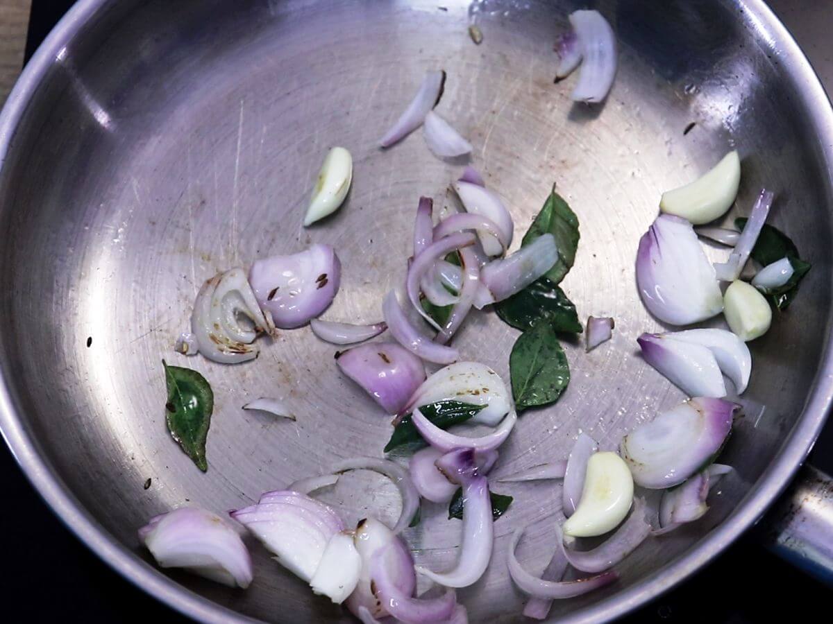 roasting onions, garlic and curry leaves.