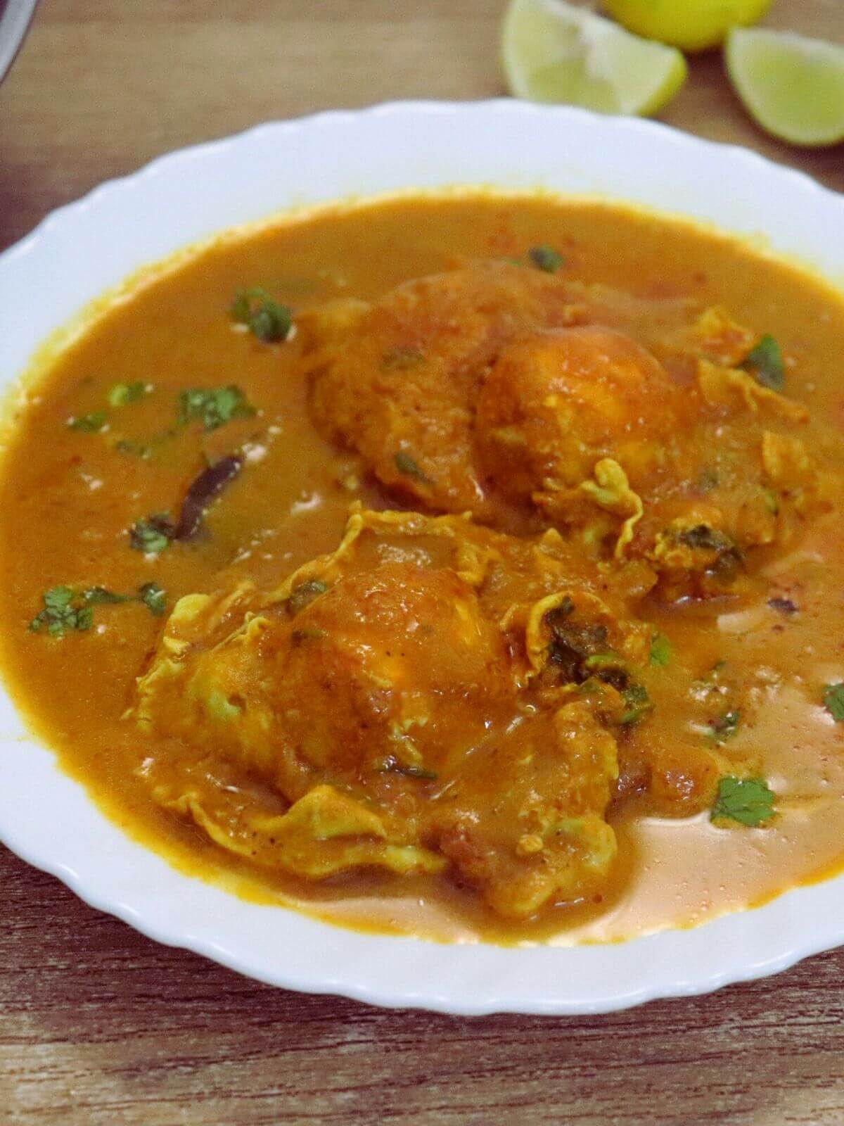 Close-up of egg drop curry with two poached eggs on a plate.