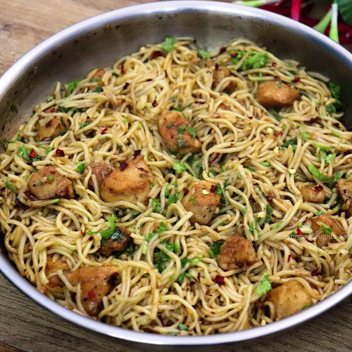 close-up of garlic butter chicken pasta. garnished with fresh parsley.
