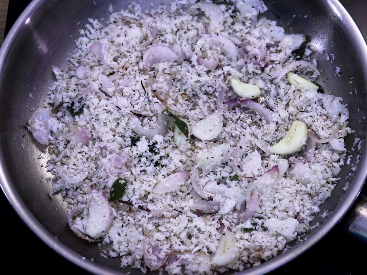 addition of coconut and roasting it with onion and garlic to make egg drop curry masala.