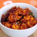 close-up of prawn masala served in a white bowl.