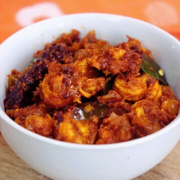 close-up of prawn masala served in a white bowl.