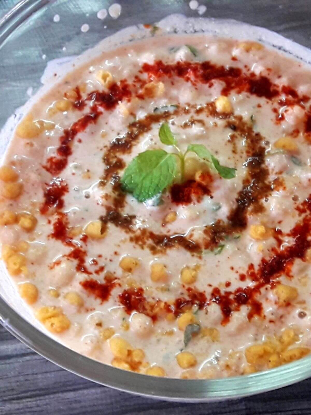 close-up of boondi raita in a bowl.