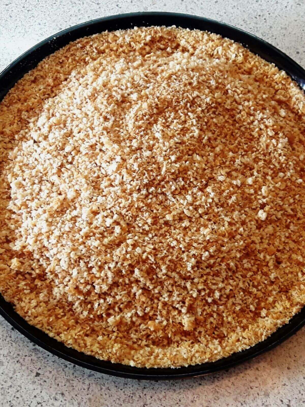 close-up of homemade breadcrumbs on a black colored plate.