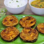close-up of brinjal fry served in a plate.