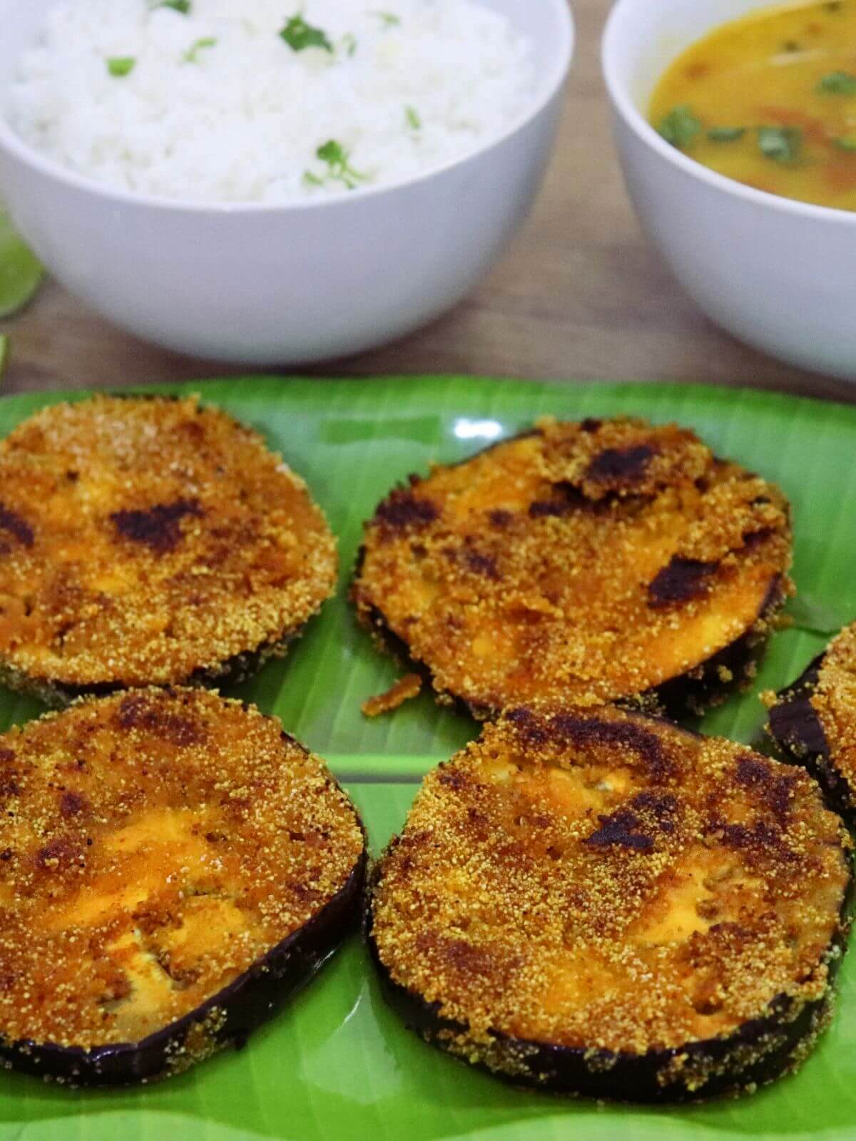 close-up of brinjal fry served in a plate.