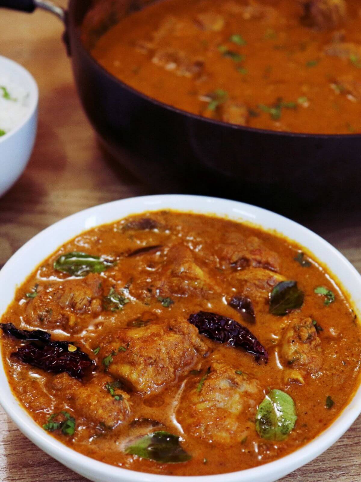 close-up of chettinad chicken curry served in a bowl.
