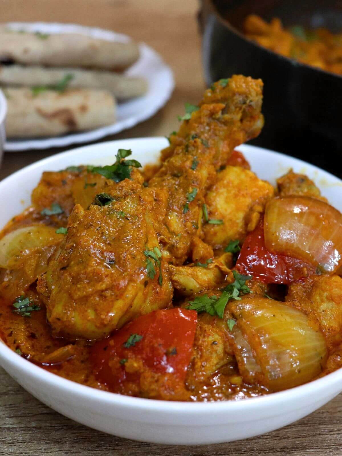 close up of chicken do pyaza served in a bowl.