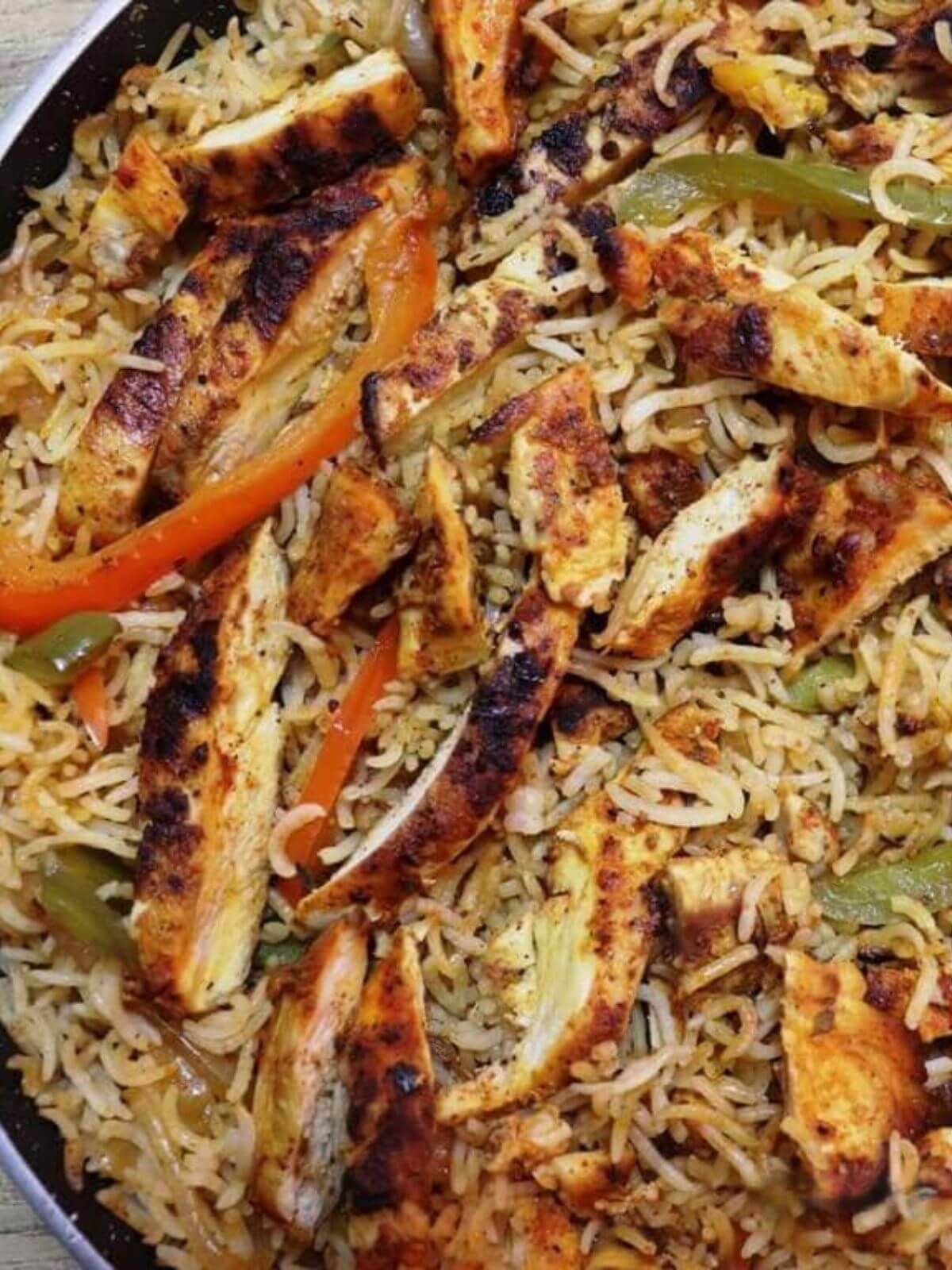 close-up of chicken fajita rice in a pan.