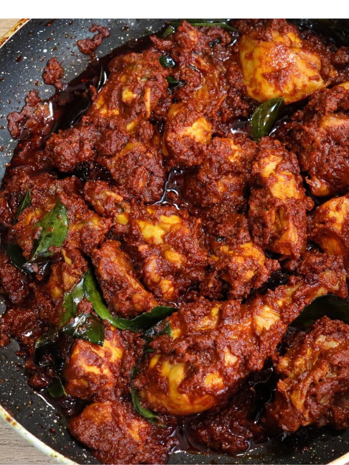 close-up of chicken ghee roast in a pan.