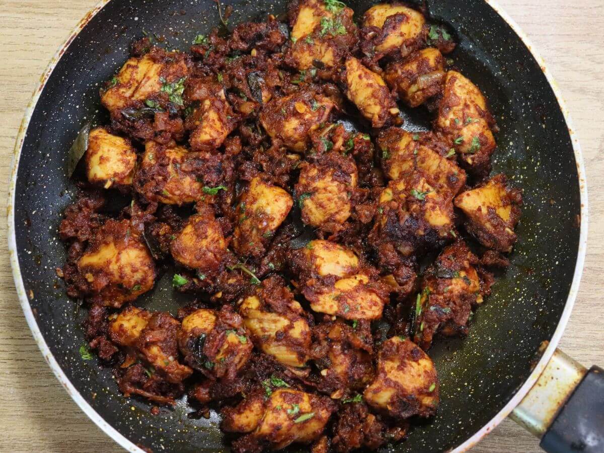 close-up of chicken masala fry in a skillet.