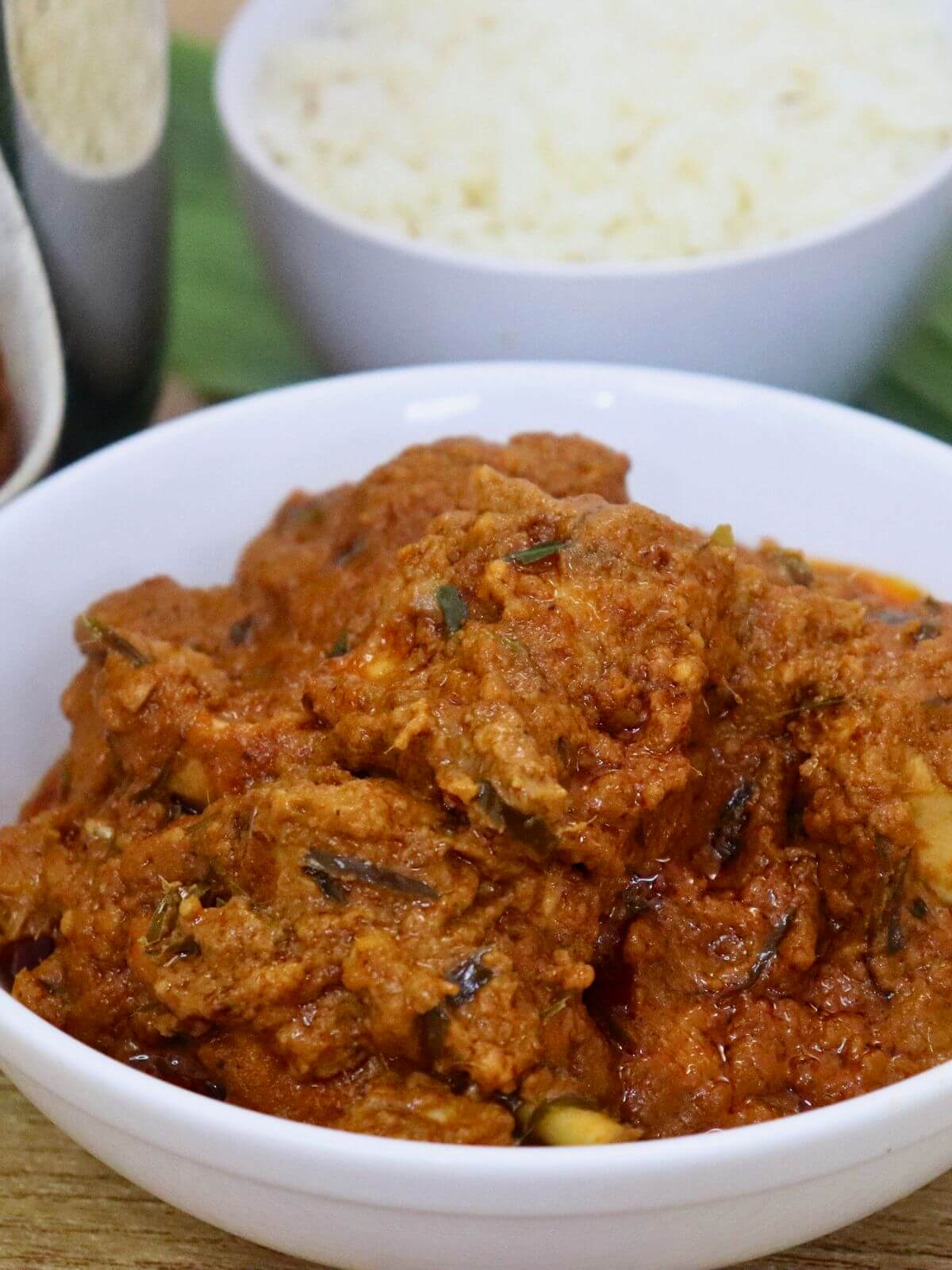 close-up of chicken rendang served in a bowl.
