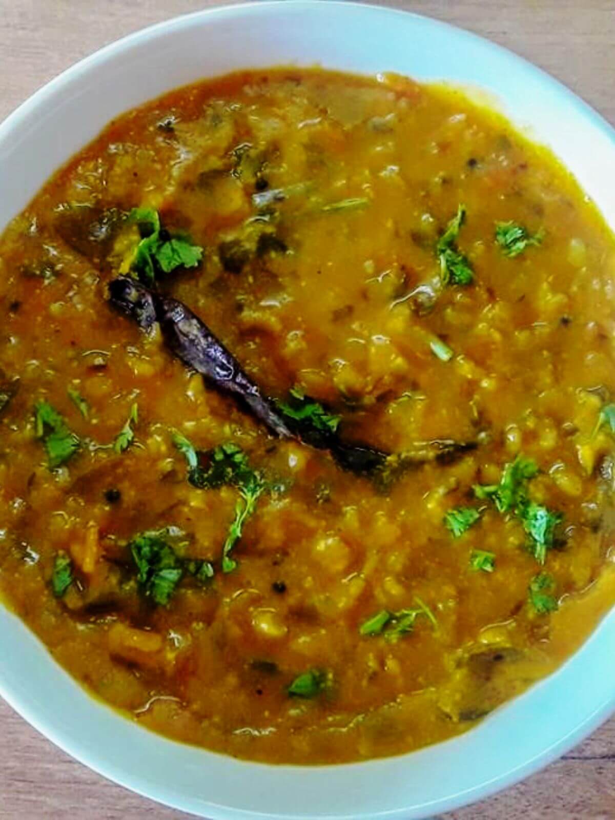close-up of dal fry in a white bowl.