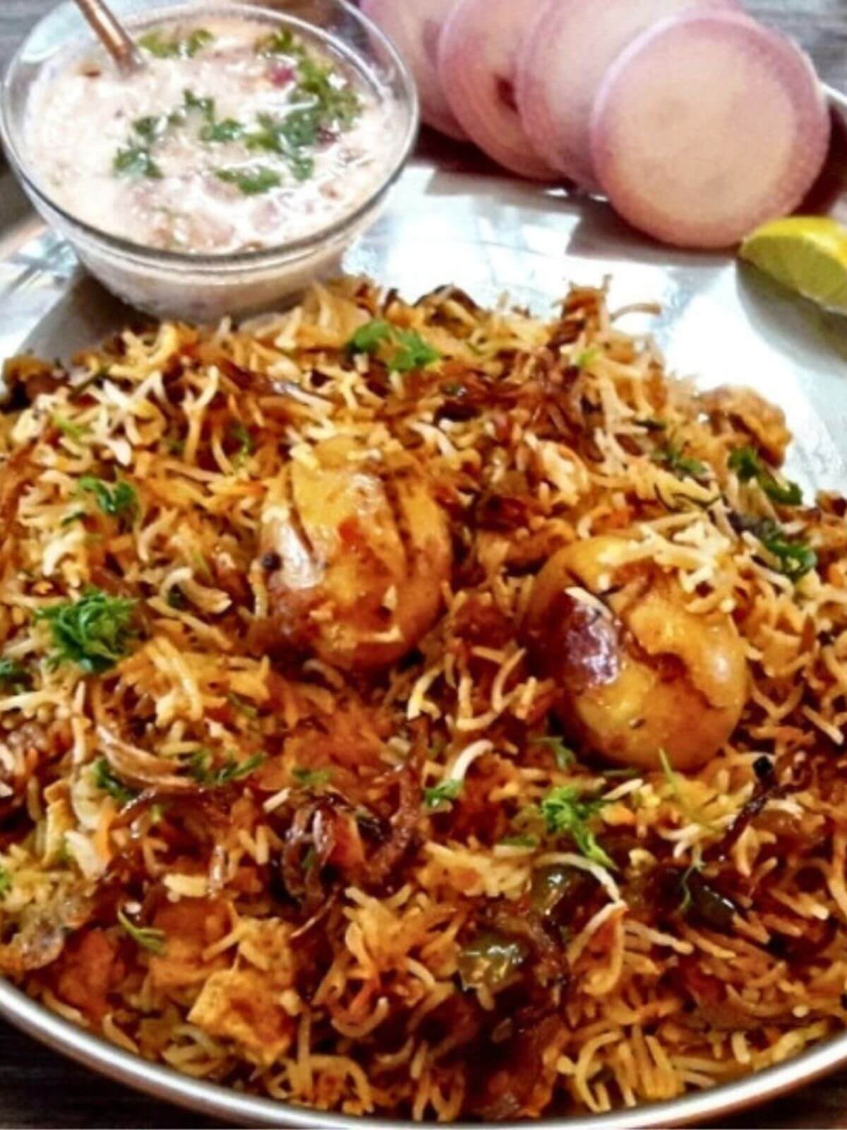 close-up of egg dum biryani served in a plate.