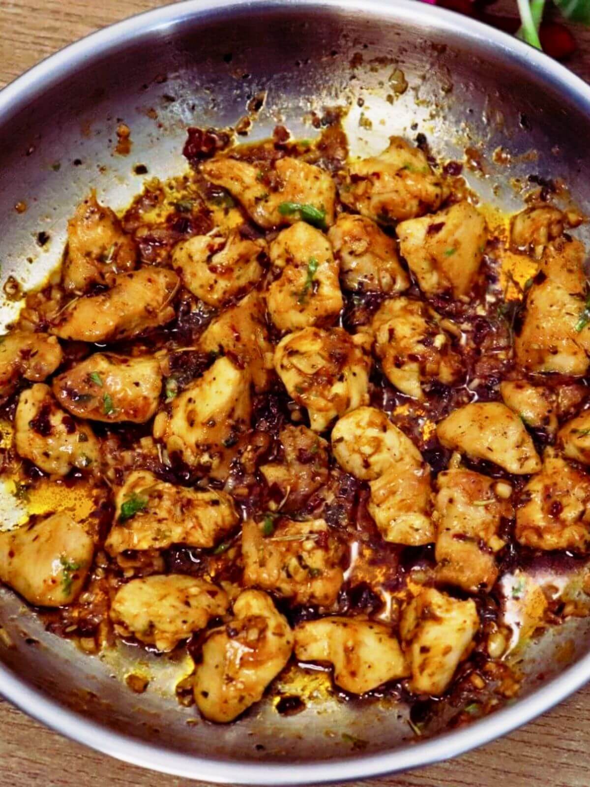 close-up of garlic butter chicken bites in a skillet.