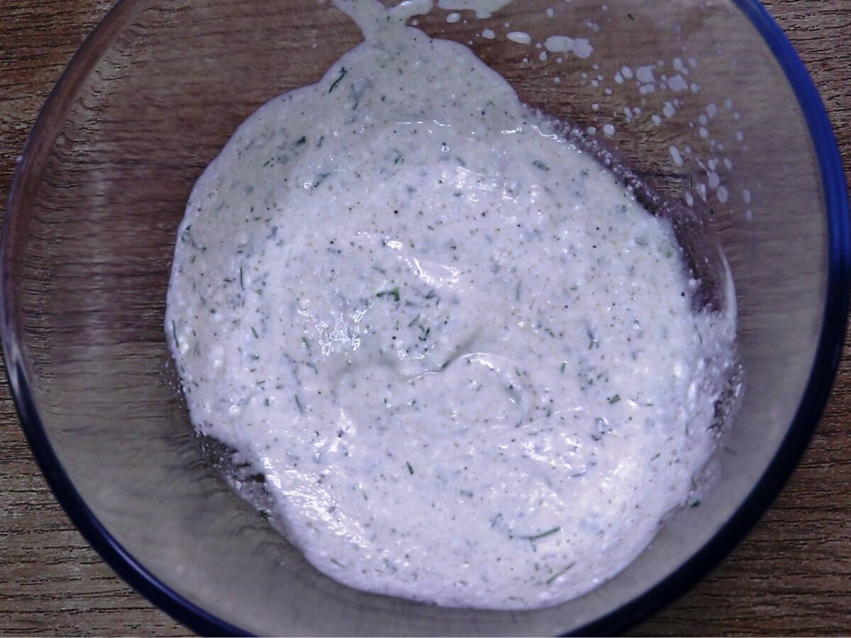 greek yogurt dressing for cucumber salad in a bowl.