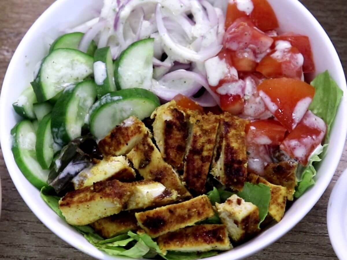 prepared chicken shawarma salad bowl with greek yogurt dressing.