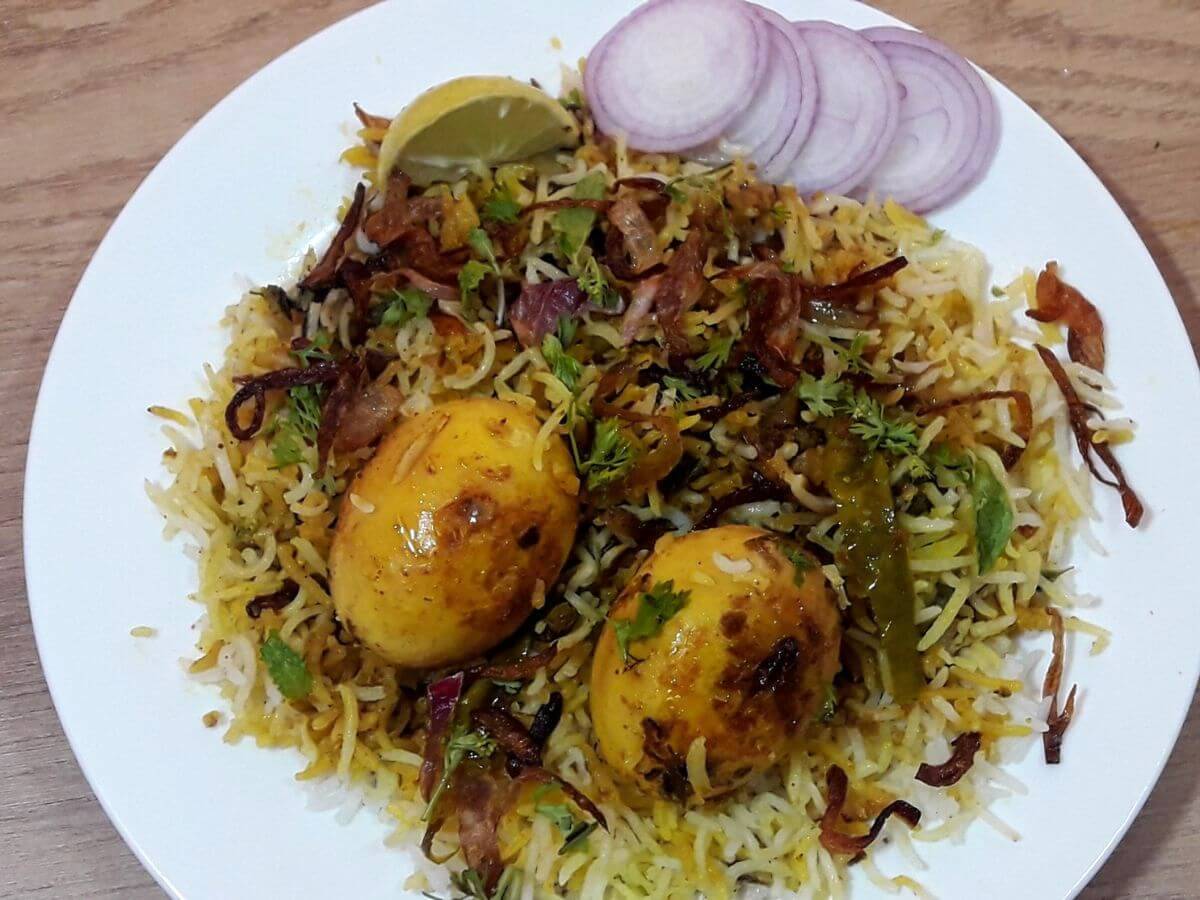 close-up of hyderabadi egg dum biryani served on a plate.