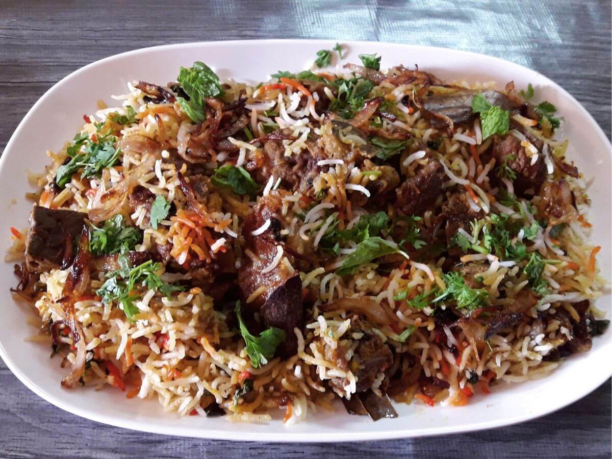 close-up of hyderabadi mutton biryani served on a plate.
