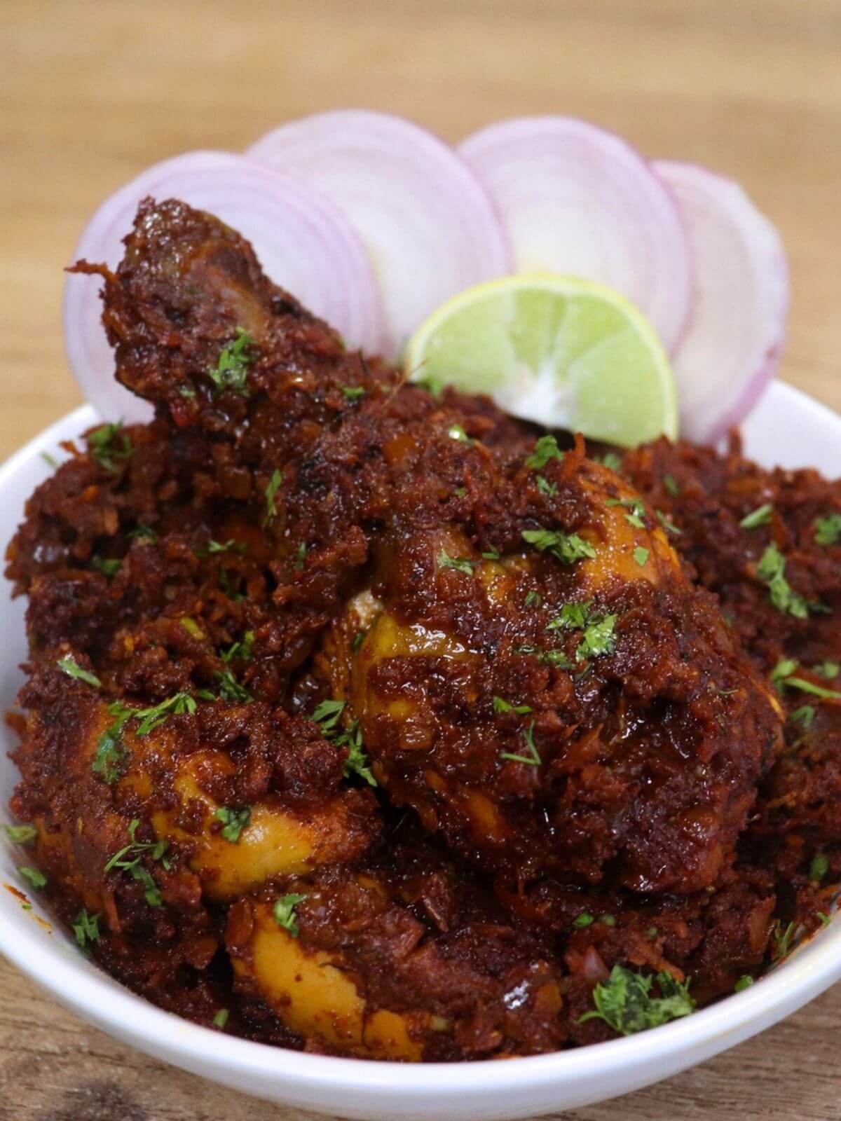 close-up of kolhapuri chicken sukka served in a bowl.