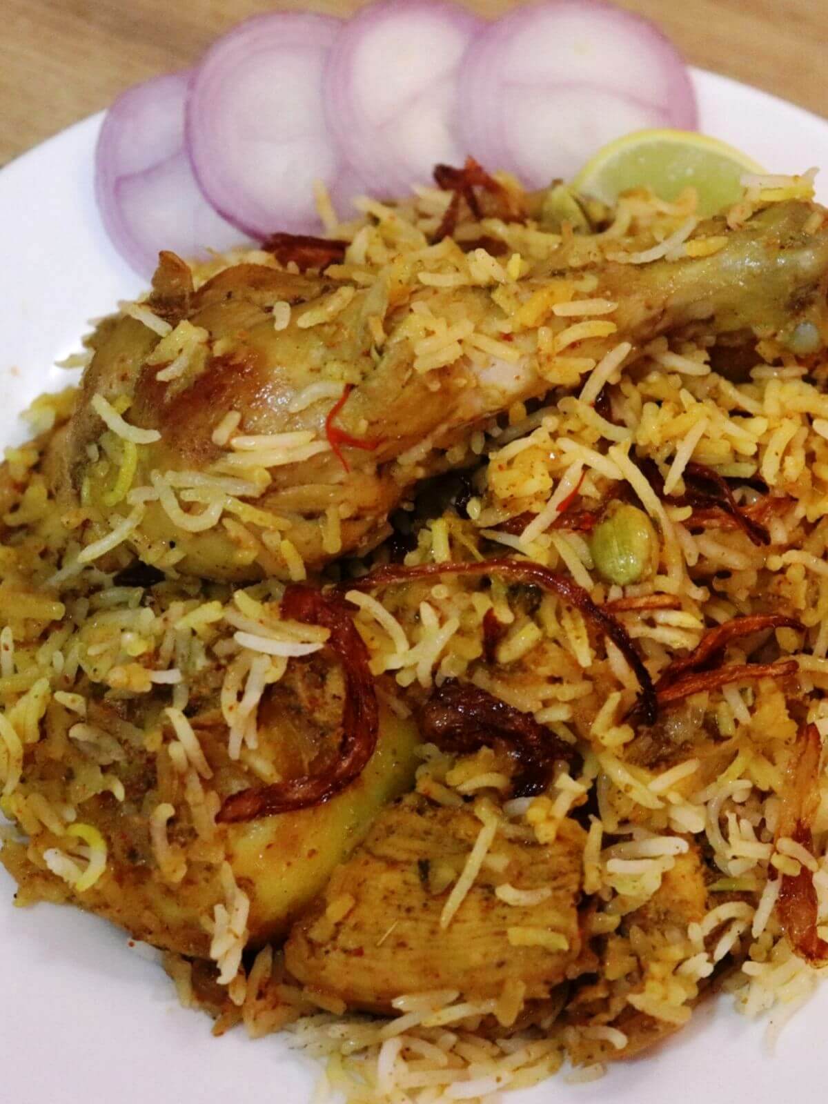 close-up of kolkata chicken biryani served on a plate.
