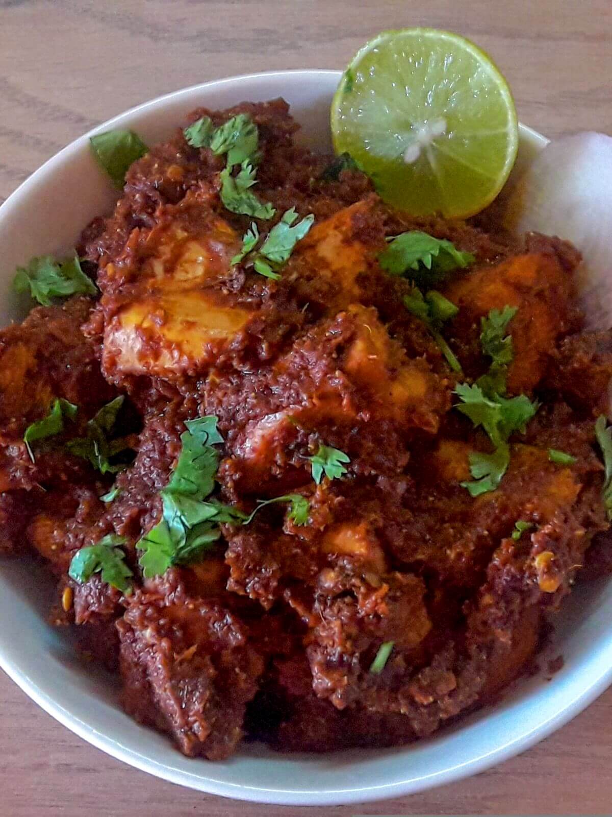 close-up of maharashtrian chicken sukka served in a bowl.