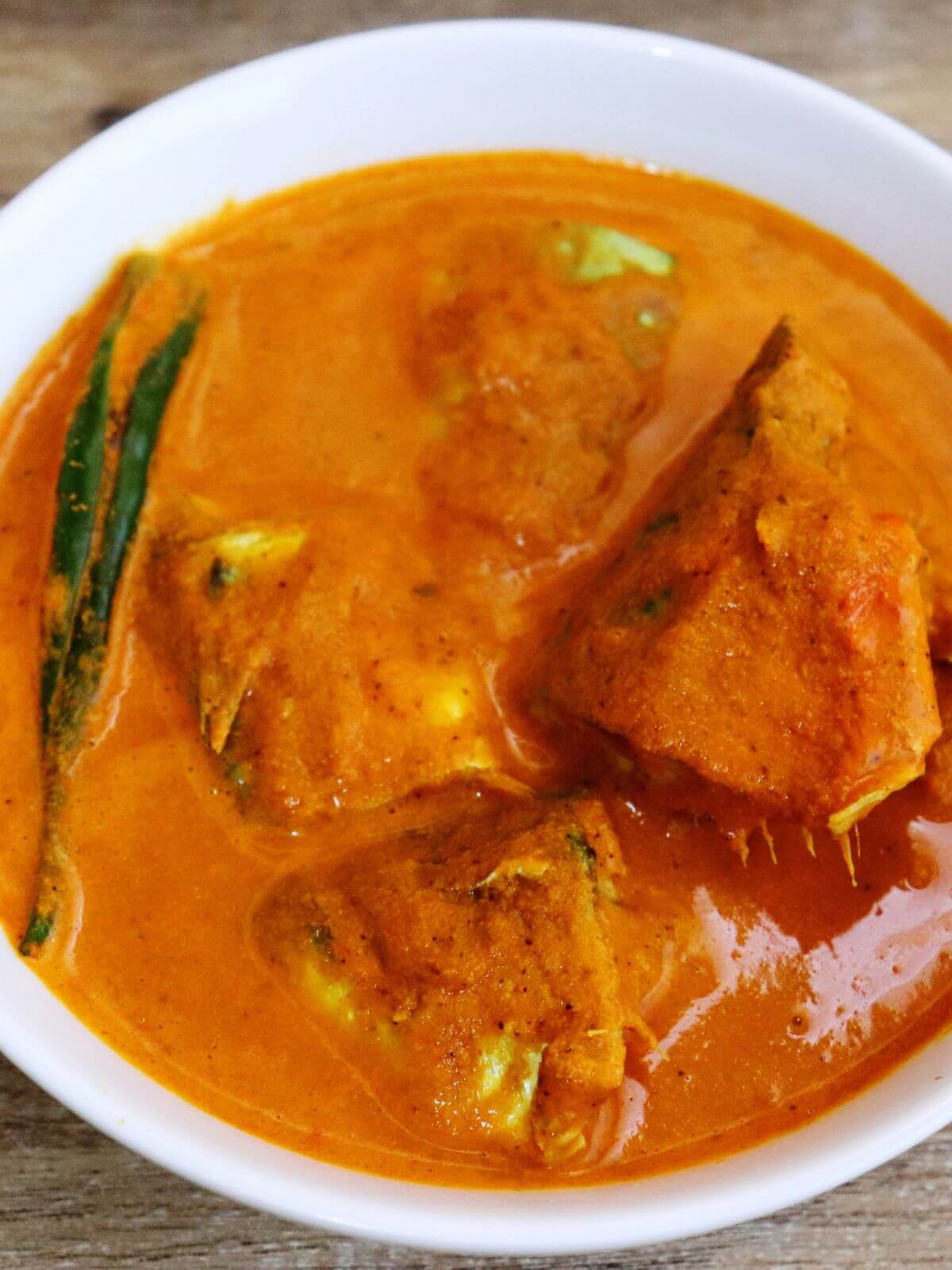 close-up of mackerel curry served in a bowl.