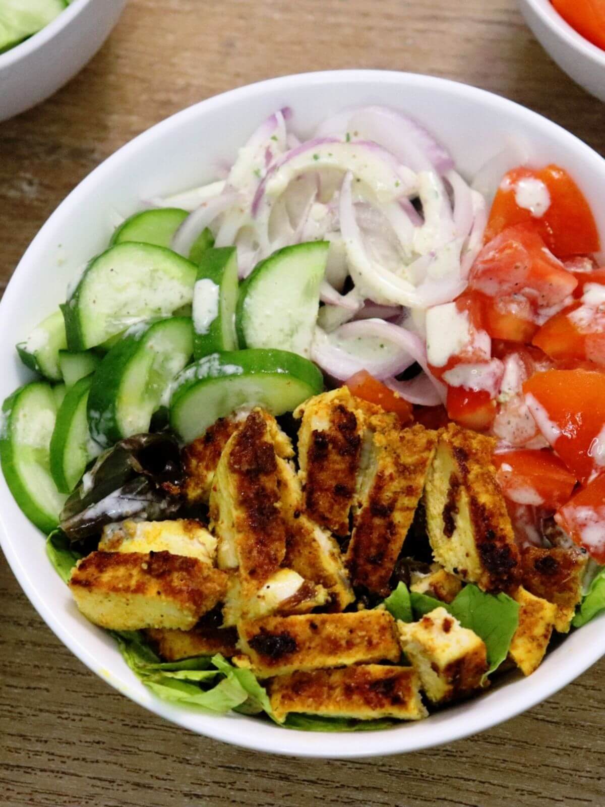 close-up of mediterranean chicken shawarma salad in a bowl.