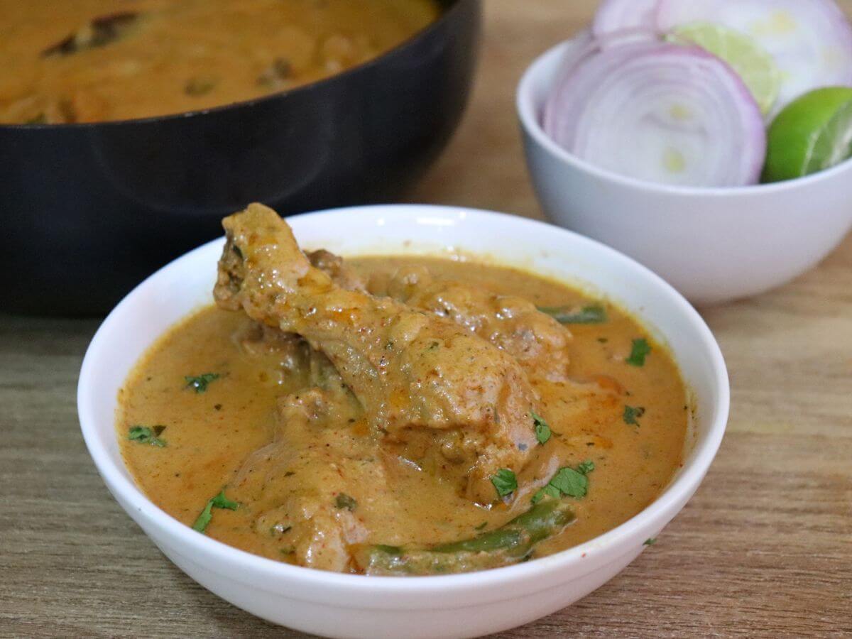 close-up of mughlai chicken served in a bowl.