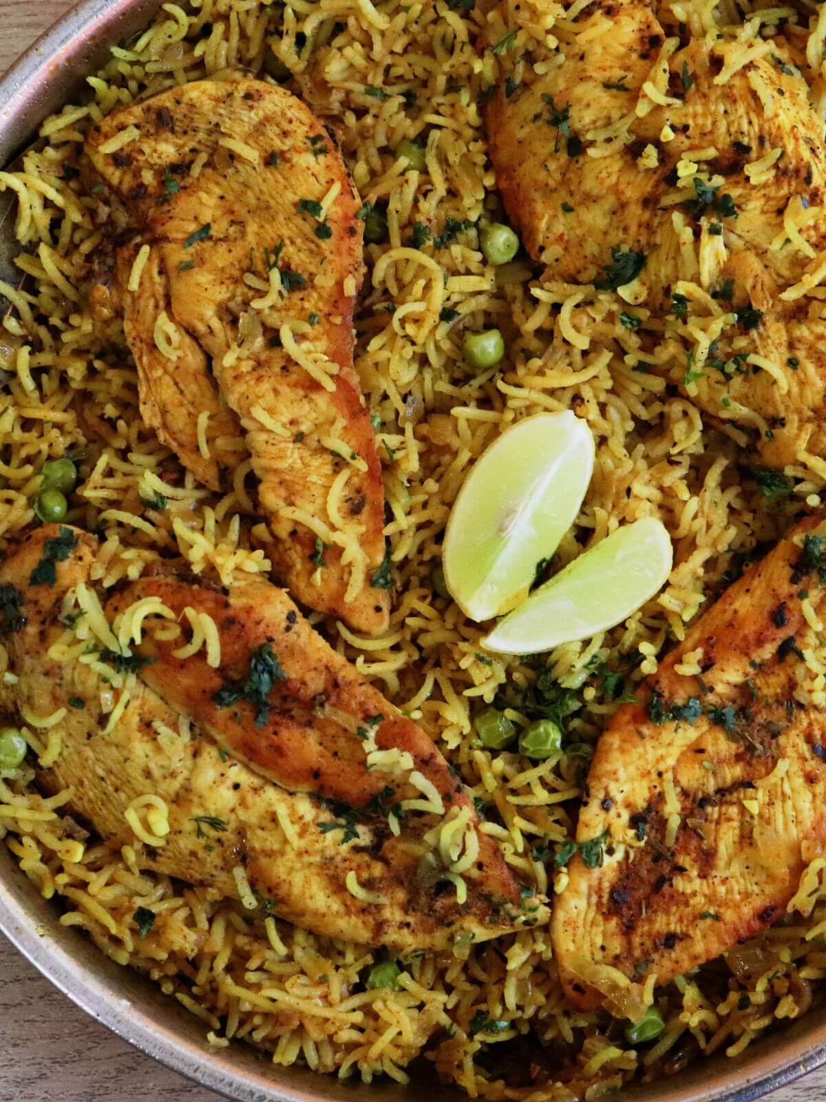 close-up of mediterranean chicken and rice in a skillet.