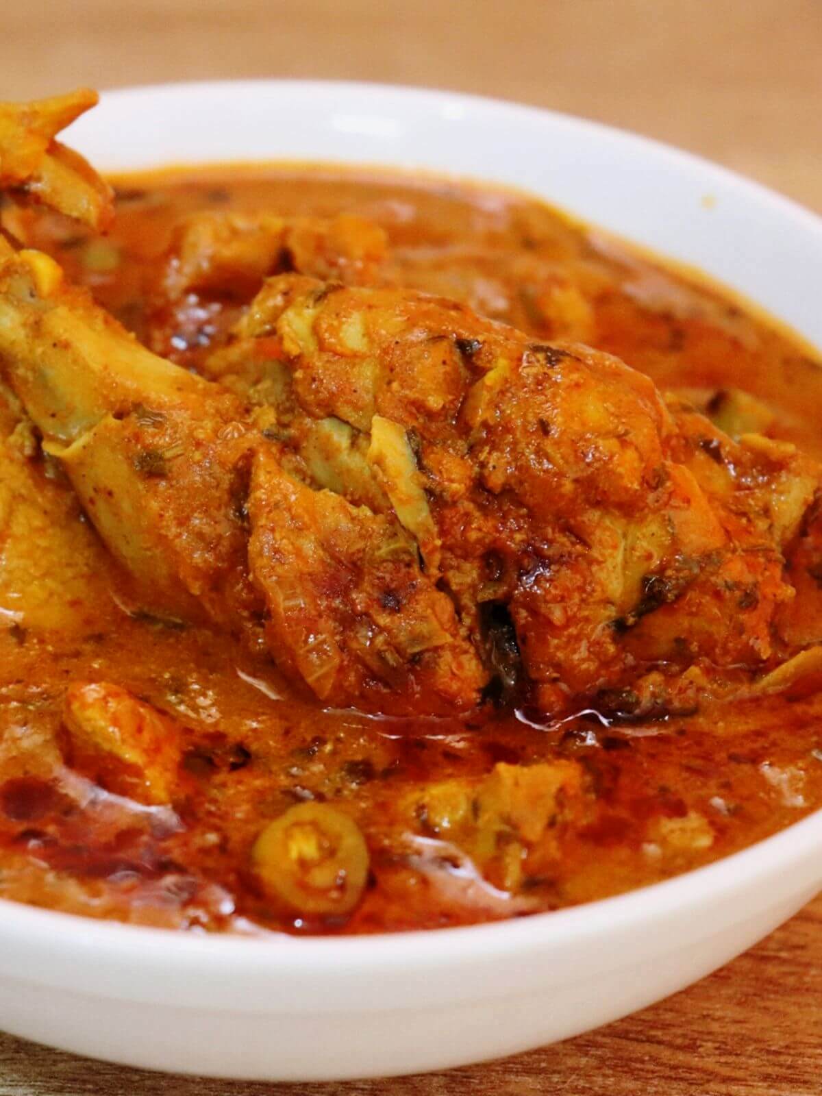 close-up of restaurant style chicken curry served in a bowl.