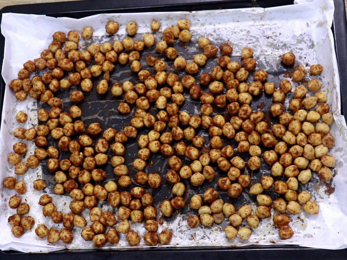 roasted chickpeas on a baking tray to make kale salad recipe.
