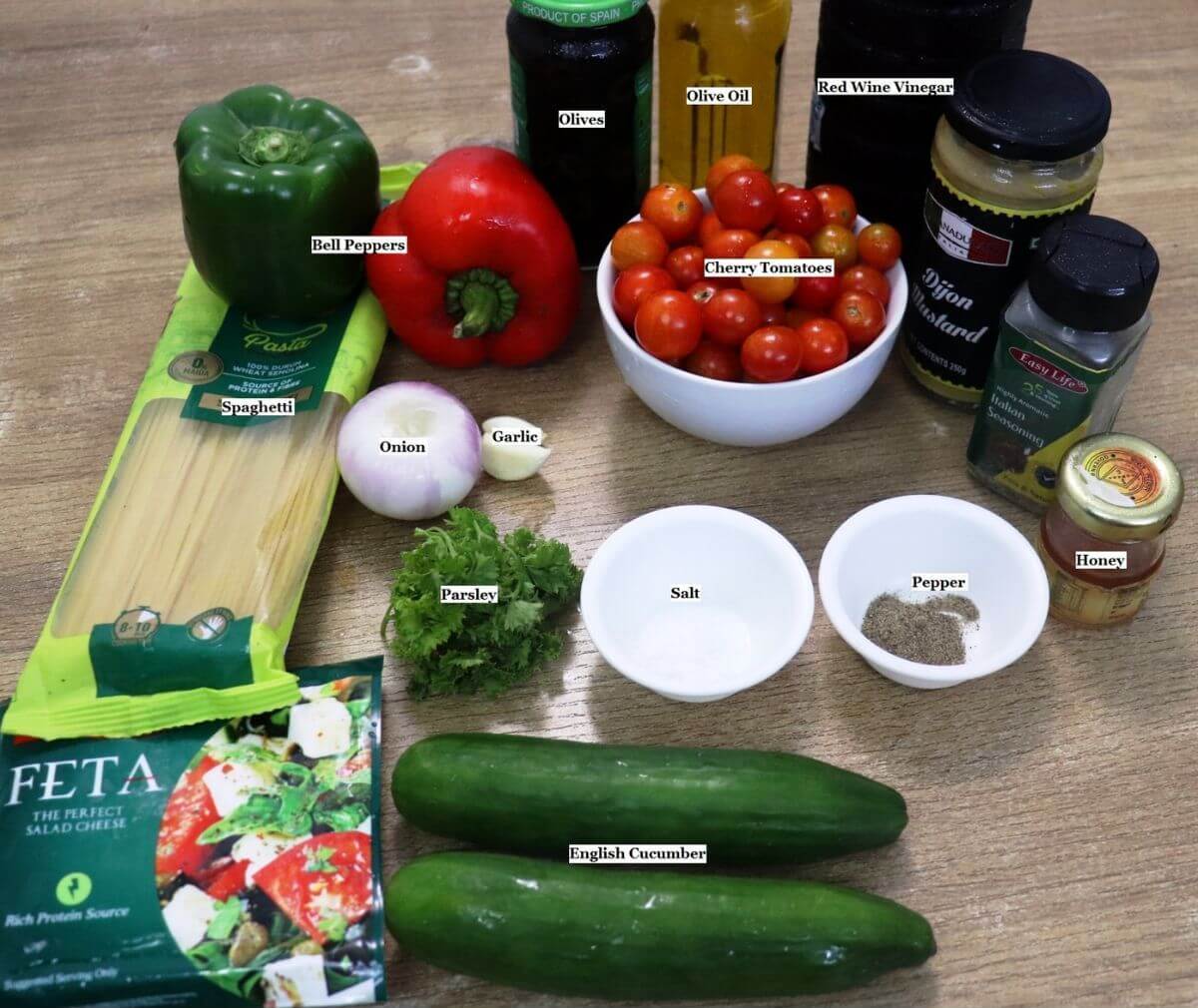 individually labeled ingredients to make spaghetti salad with chicken are laid out on a table.
